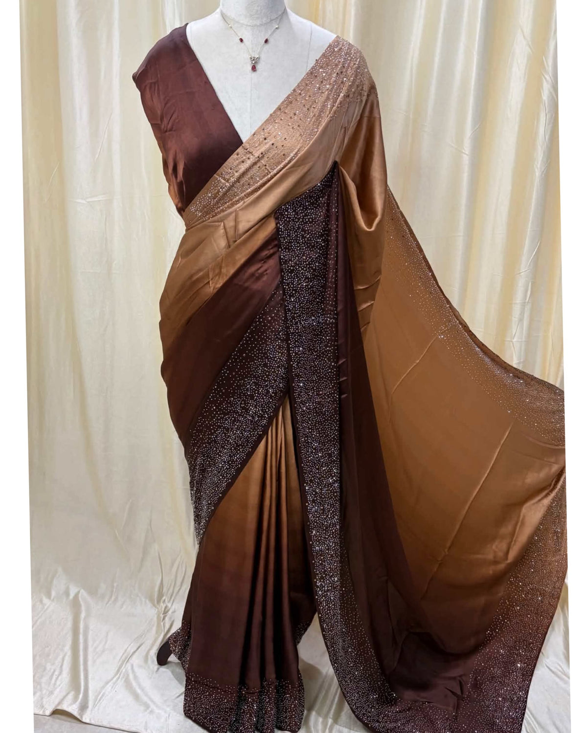 Coffee brown dual shaded satin silk saree comes with stone work all over saree.
