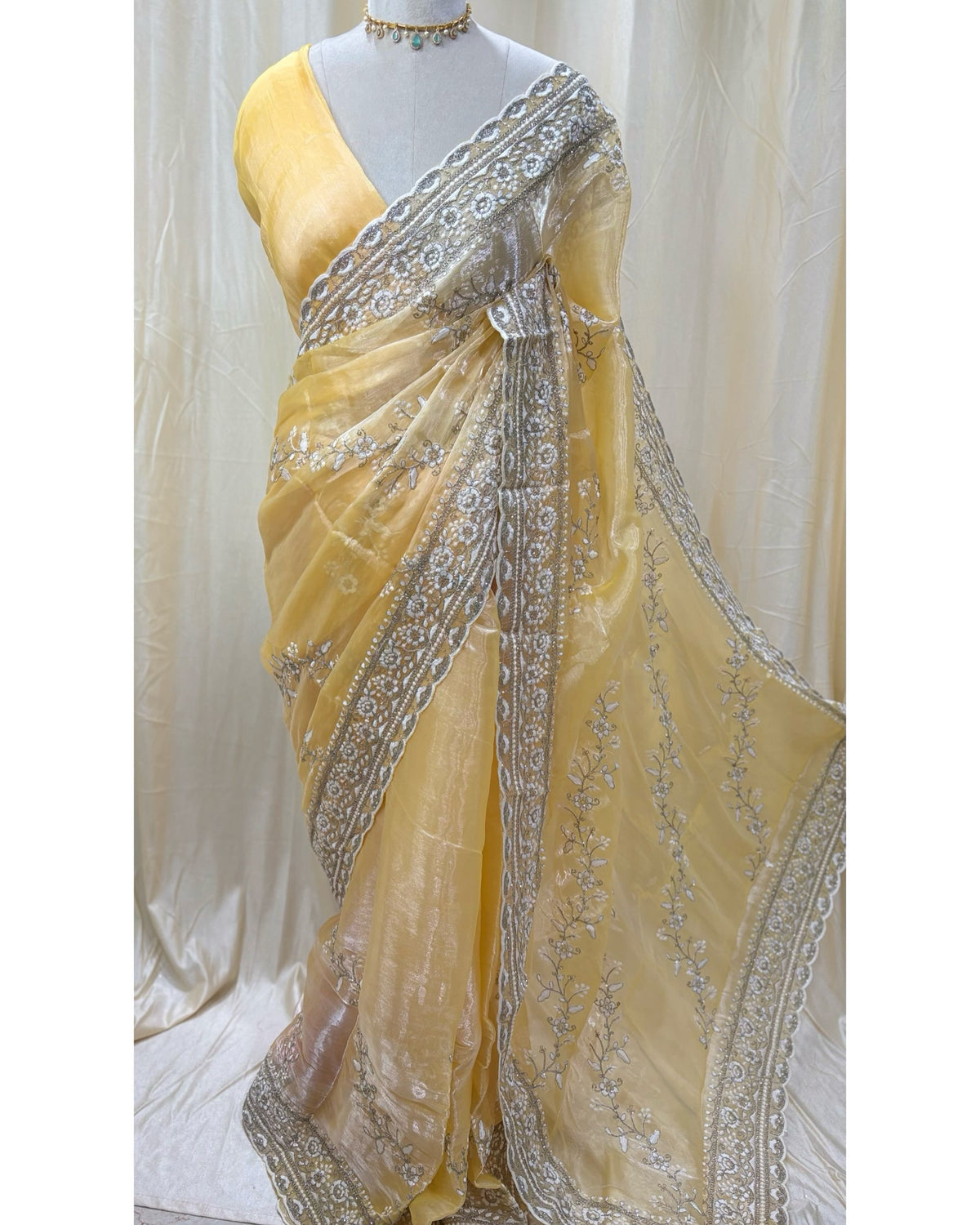 Lemon yellow soft organza saree with white embroidery all over saree.