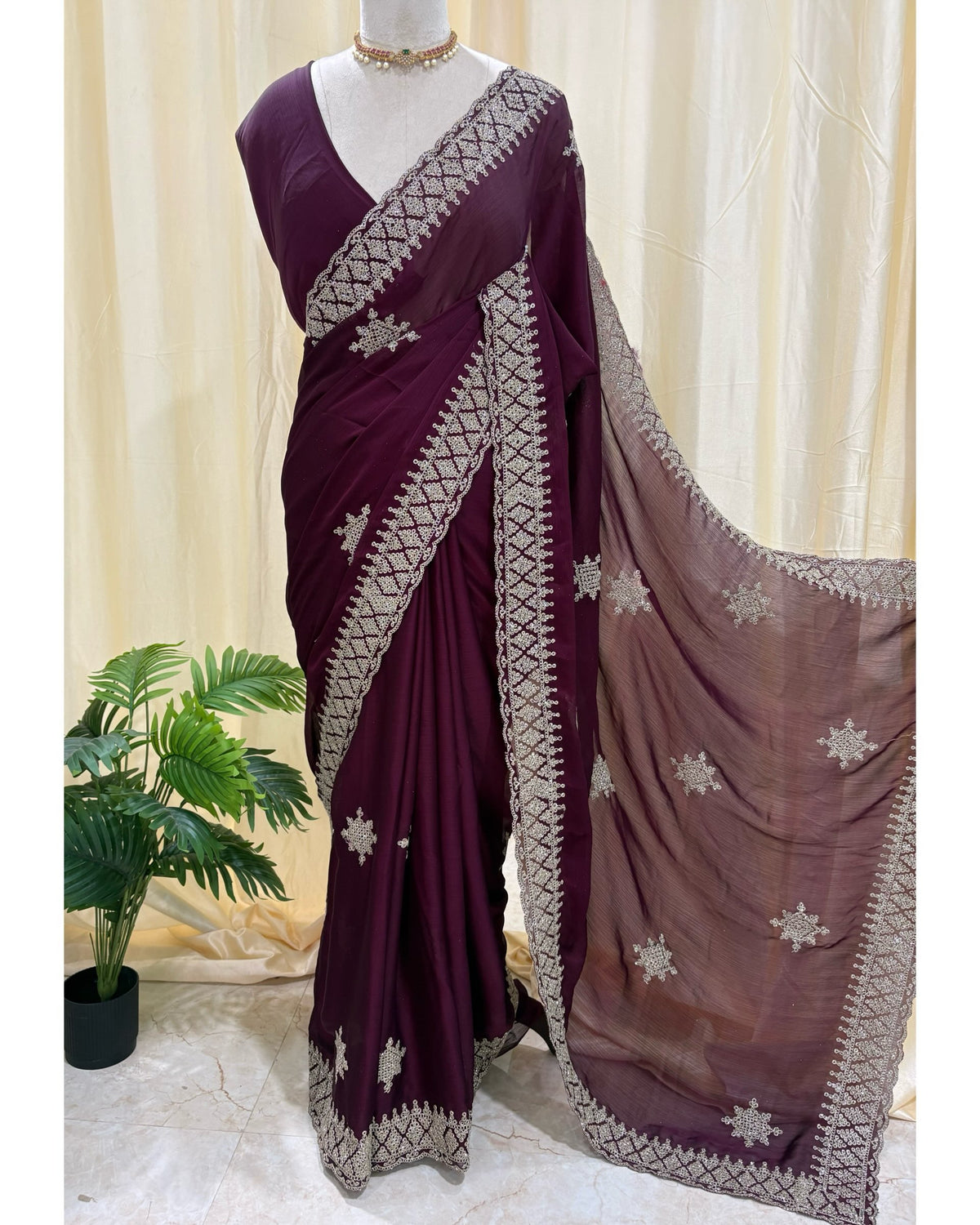 Magenta georgette saree with golden white embroidery.