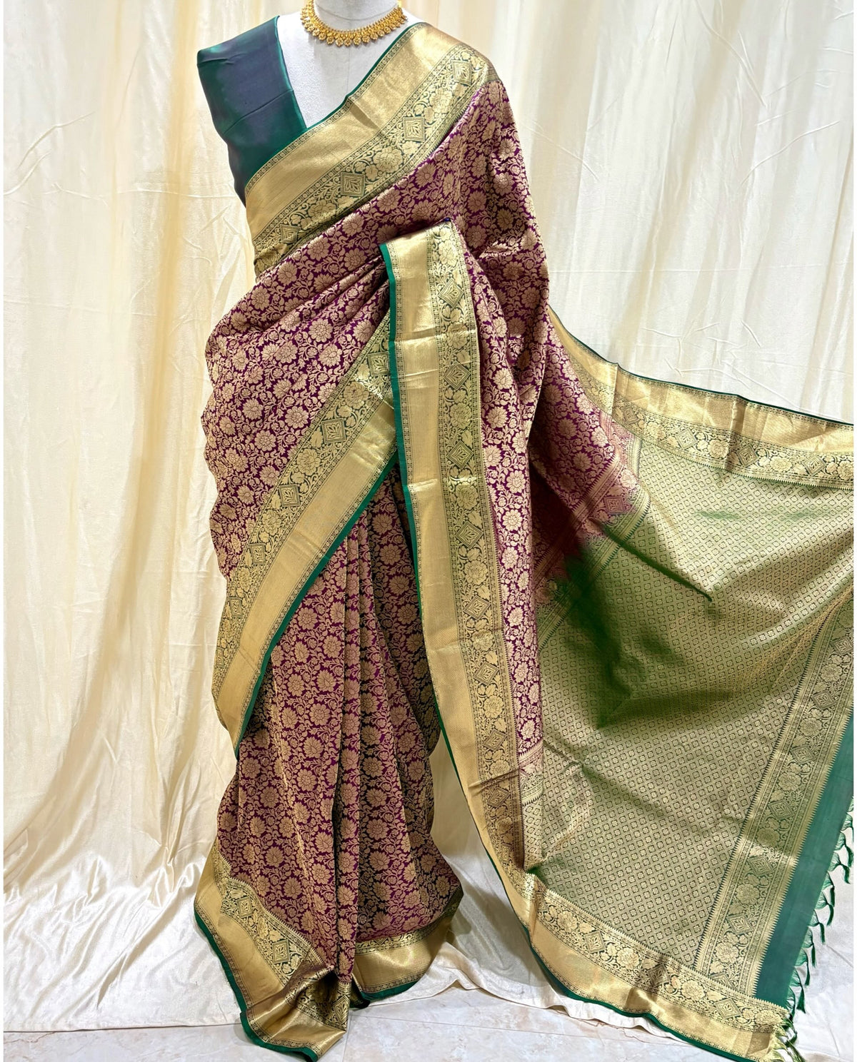 Magenta kanchipuram silk saree with peacock green border.