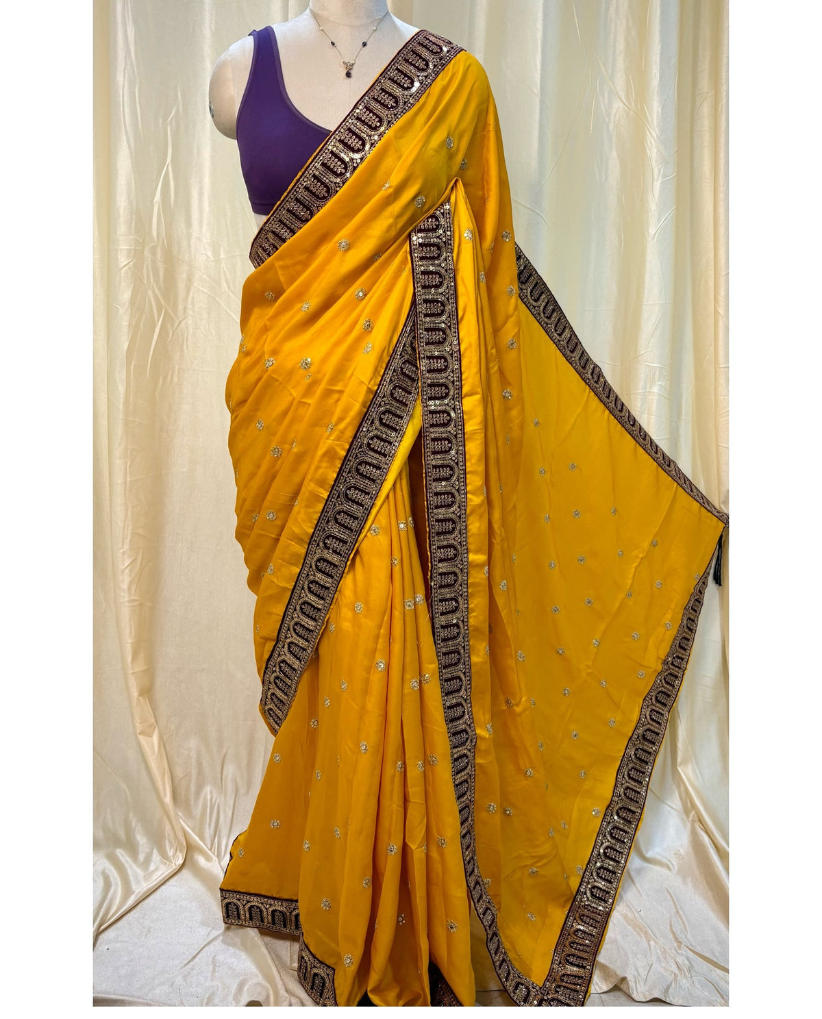 Mango yellow malai silk saree comes with Violet lace work saree.
