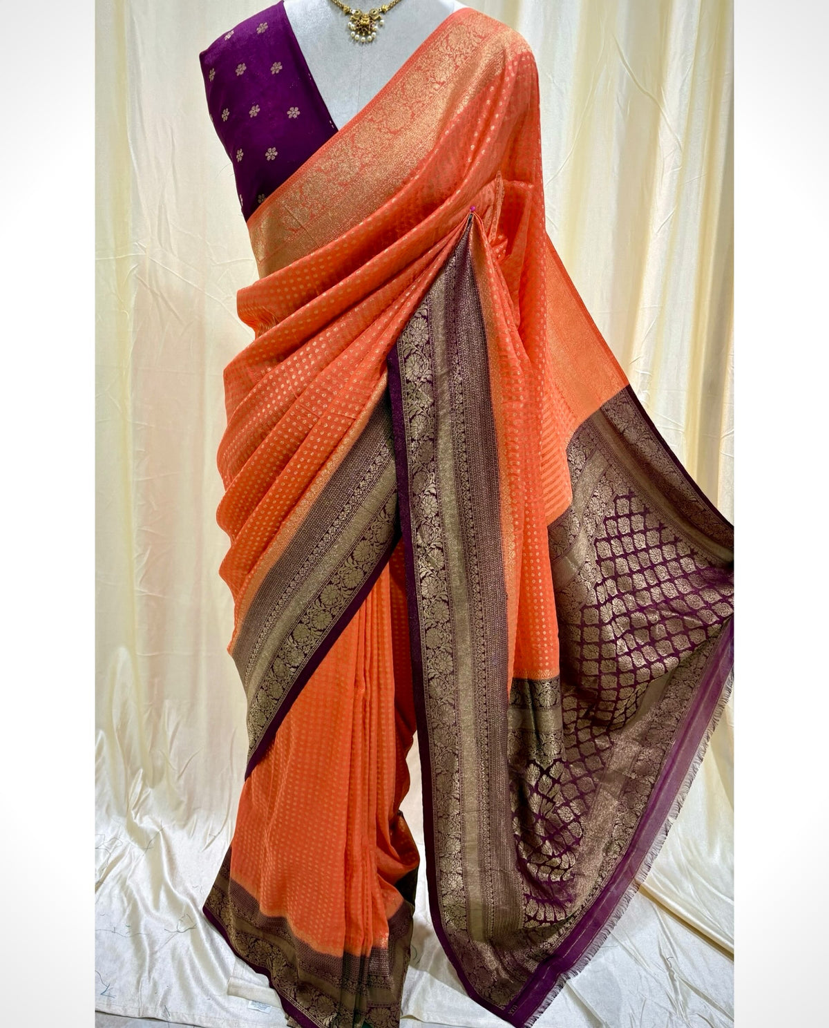 Saffron chiffon saree with magenta border.