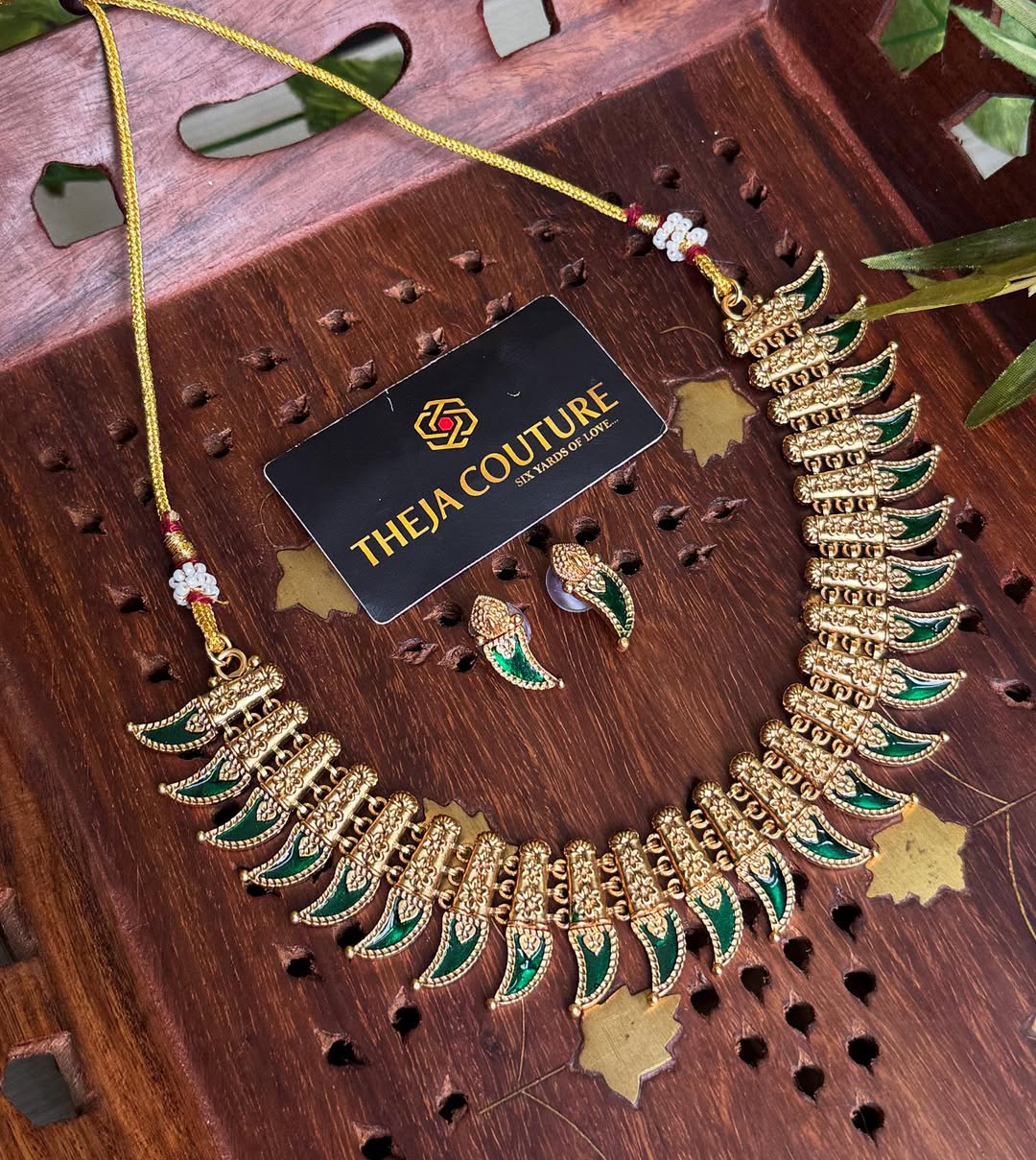 Antique gold choker with elegant green necklace.