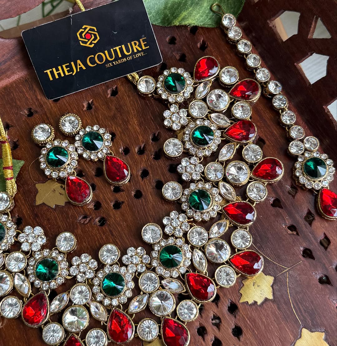 White Kundan short necklace with red and green stone.