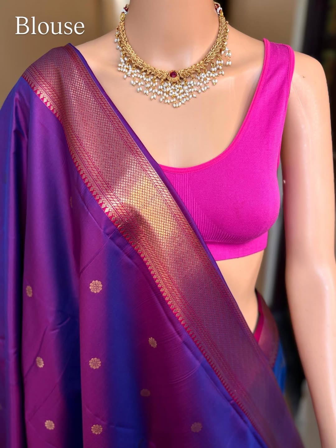 Peacock blue art silk saree comes with pink golden zari weave border.