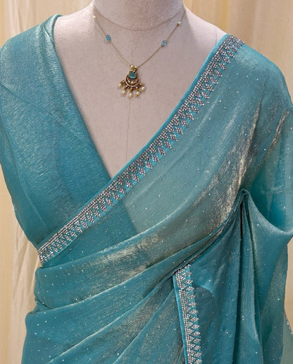 Sky blue georgette saree with white stones .