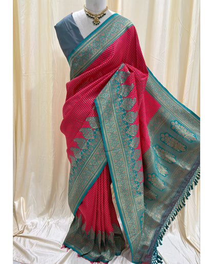 Rani pink brocade silk saree with teal blue border.