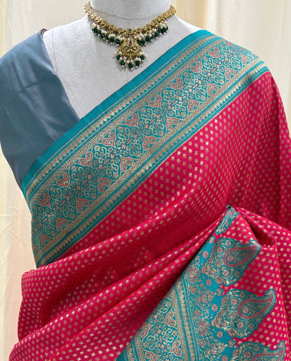 Rani pink brocade silk saree with teal blue border.