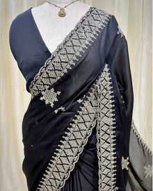 Black georgette saree with golden white embroidery.
