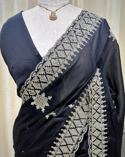Black georgette saree with golden white embroidery.