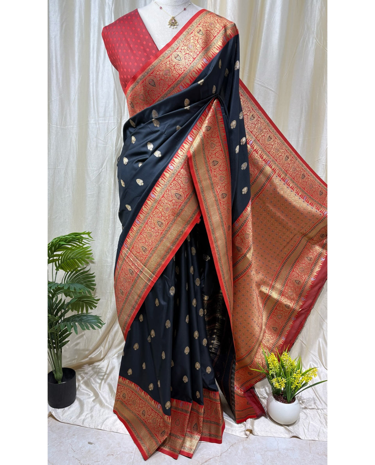 Black art silk saree with red border.