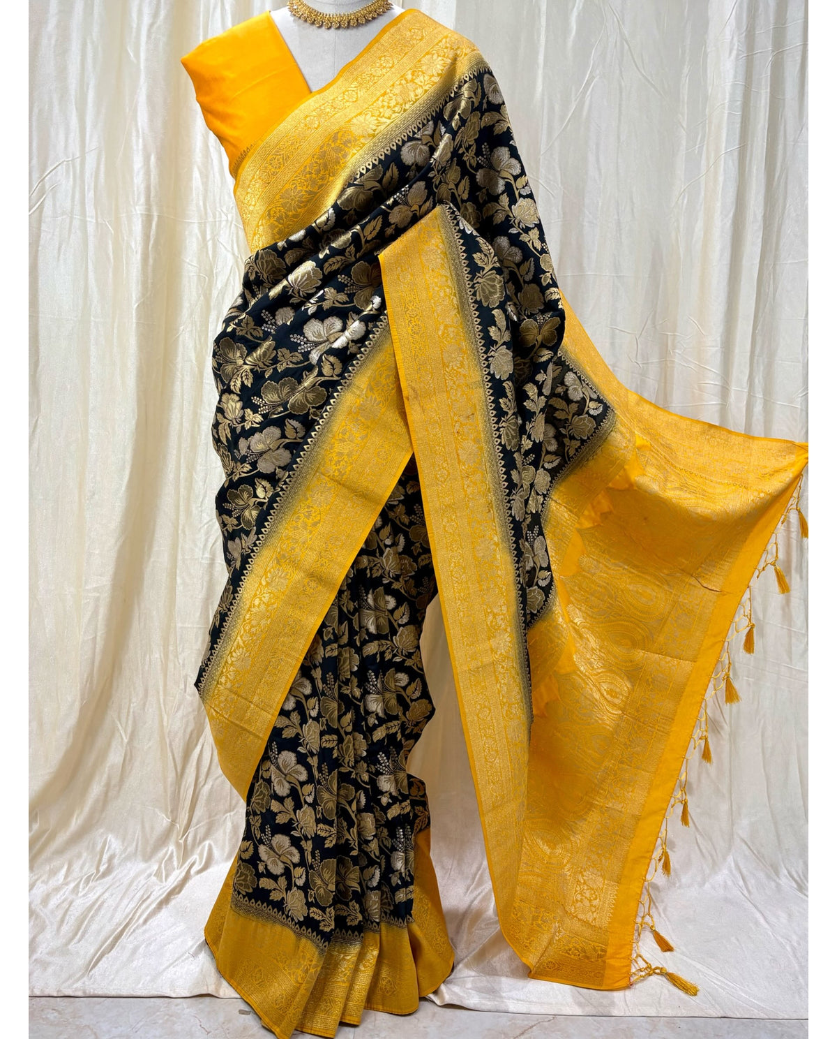 Black brocade silk saree with yellow zari border.