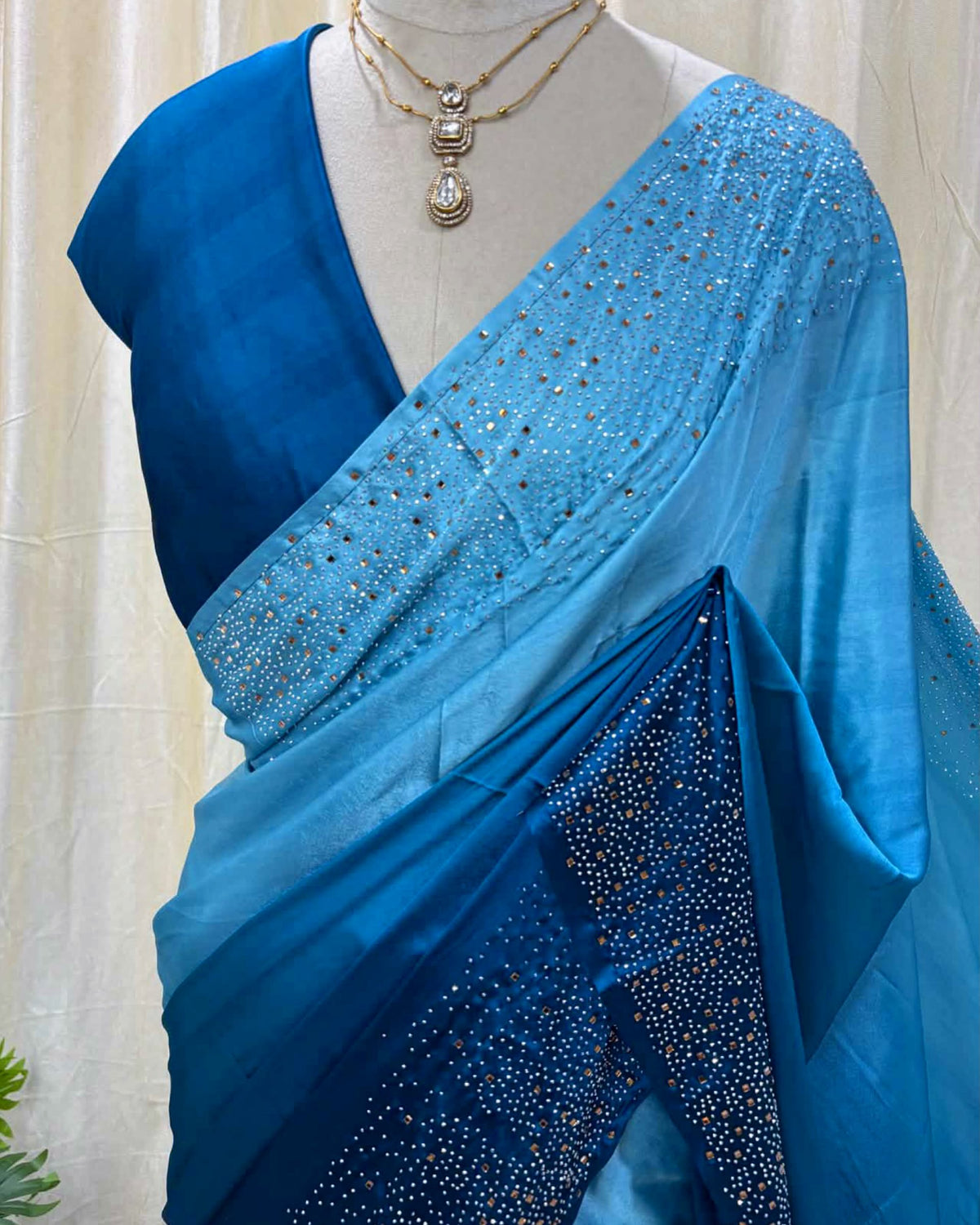 Blue dual shaded satin silk saree comes with stone work all over saree.