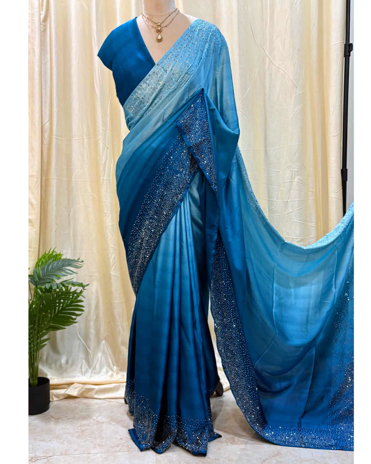 Blue dual shaded satin silk saree comes with stone work all over saree.