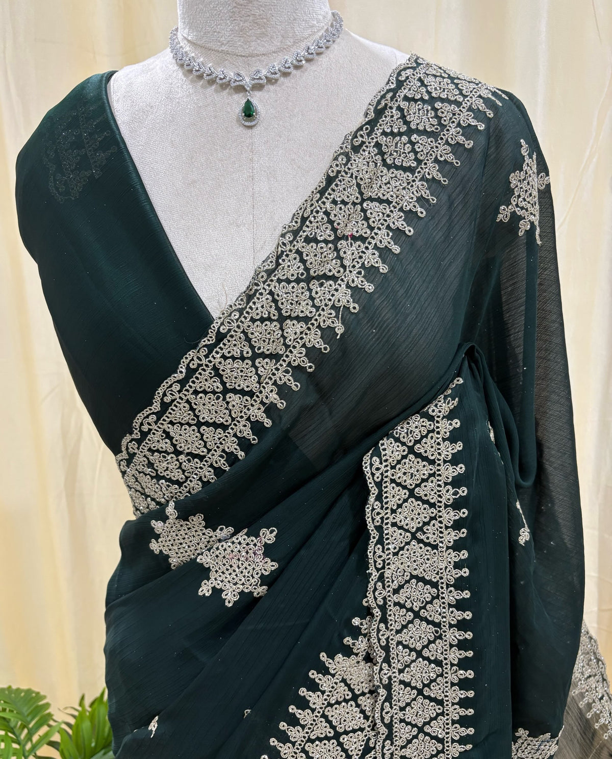 Bottle green georgette saree with golden white embroidery.