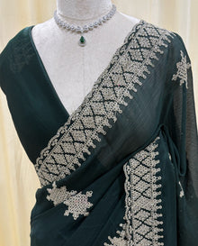 Bottle green georgette saree with golden white embroidery.