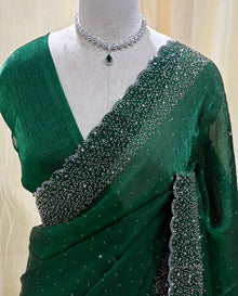Bottle green georgette saree with white stones.
