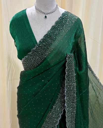 Bottle green georgette saree with white stones.