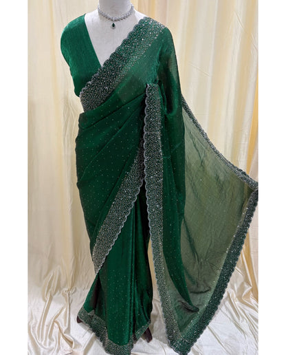Bottle green georgette saree with white stones.