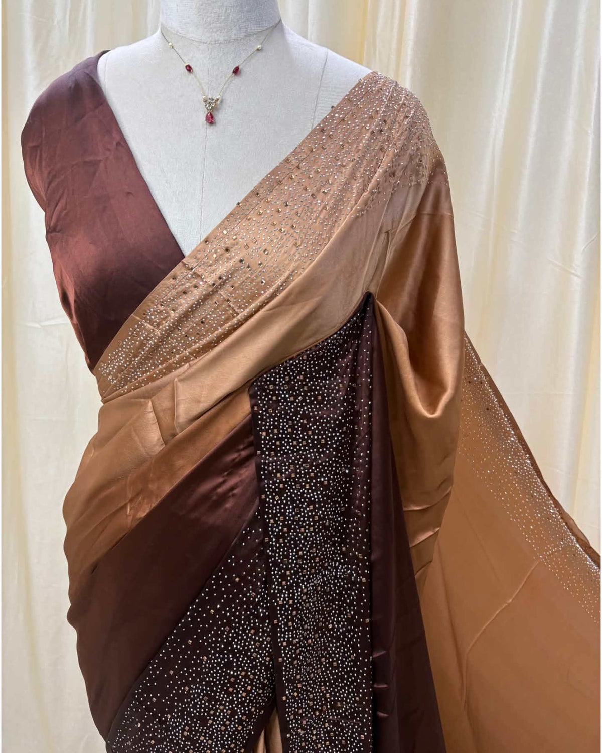Coffee brown dual shaded satin silk saree comes with stone work all over saree.