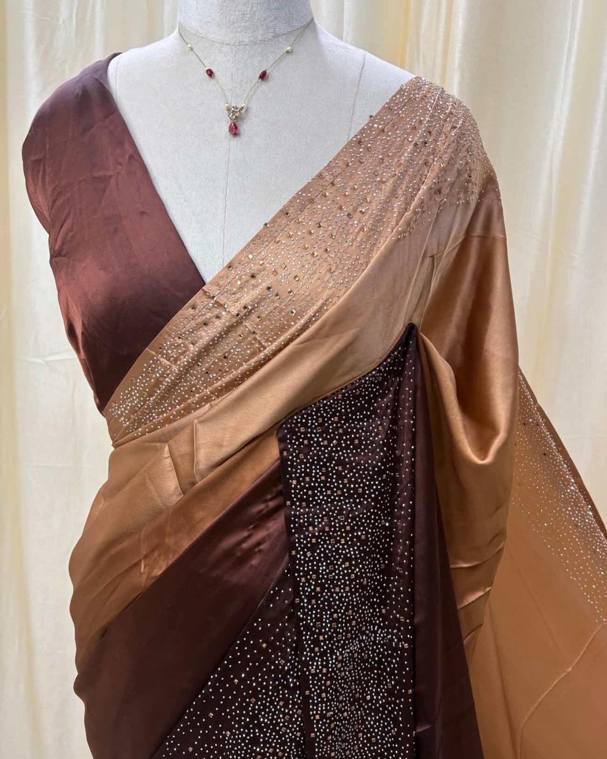 Coffee brown dual shaded satin silk saree comes with stone work all over saree.