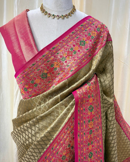 Copper gold diamond tissue silk saree with red border.
