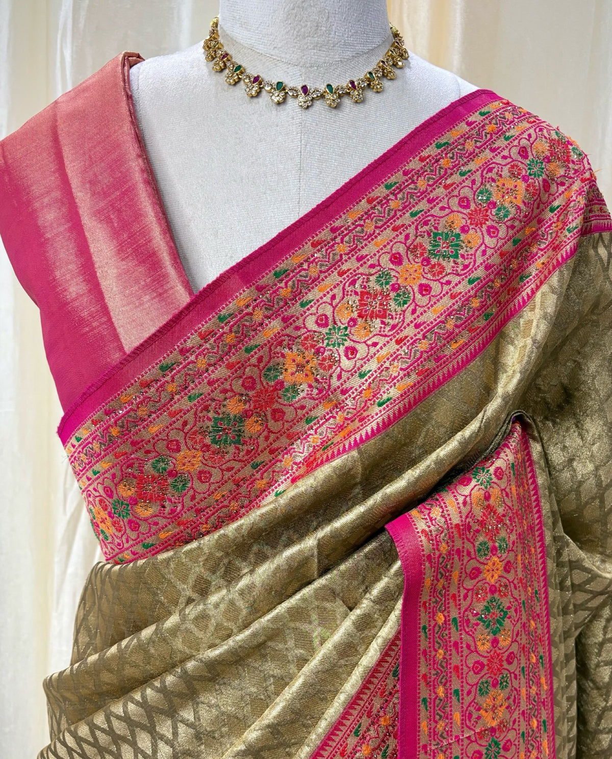 Copper gold diamond tissue silk saree with red border.