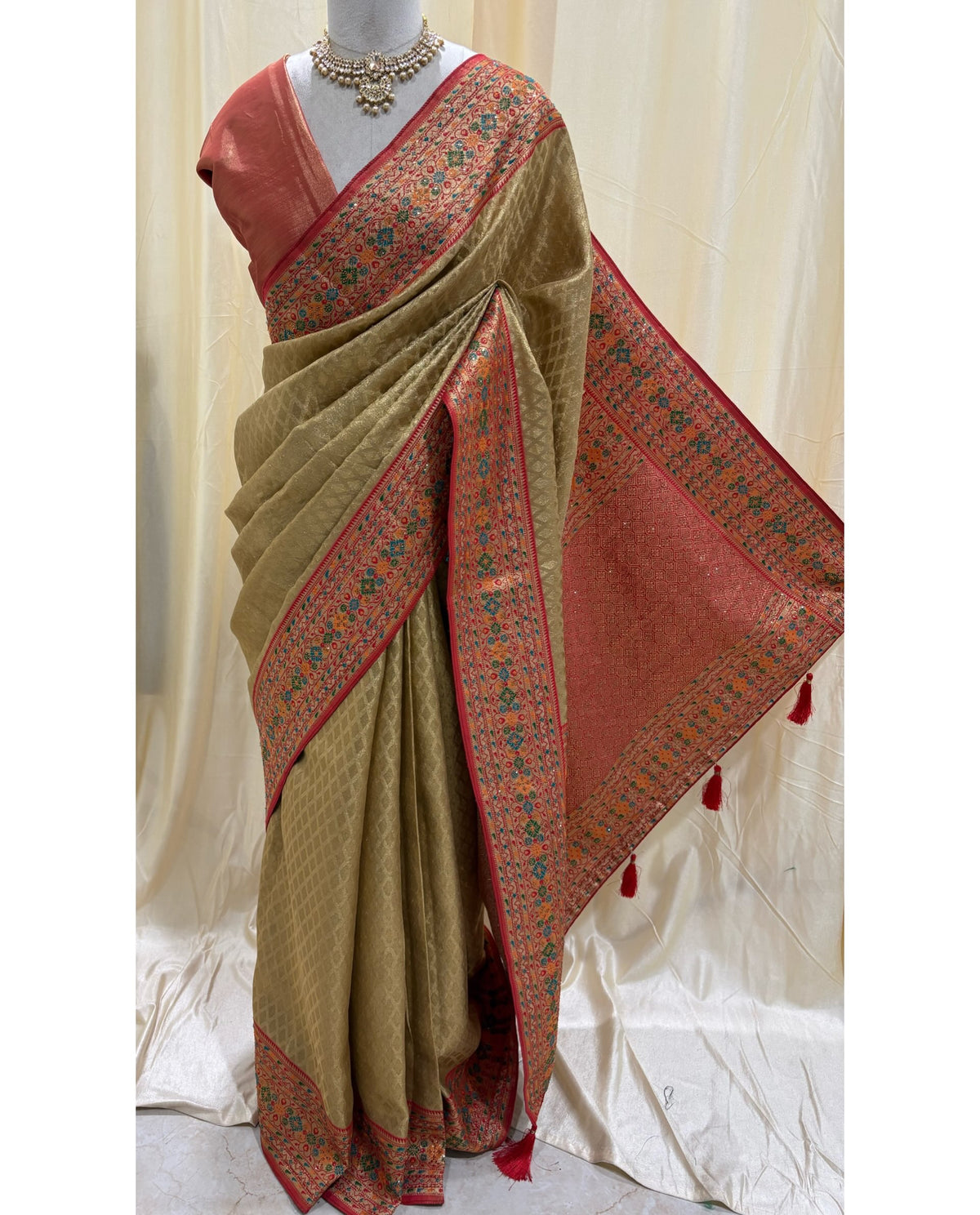Golden diamond tissue silk saree with red border.