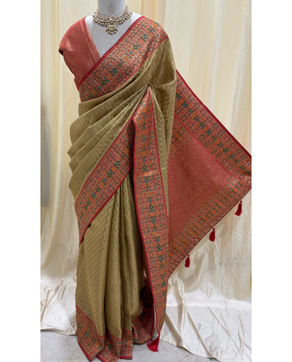 Golden diamond tissue silk saree with red border.