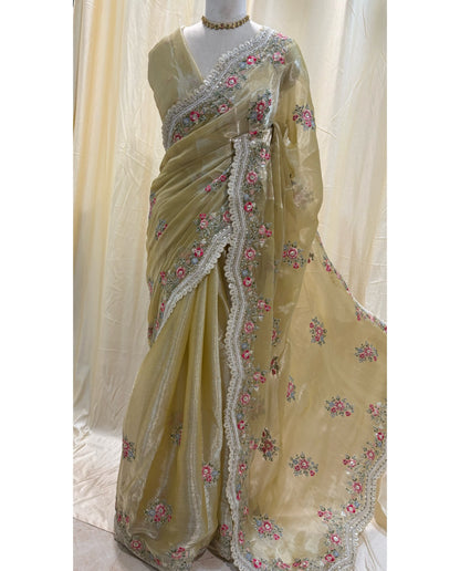 Golden yellow soft organza saree with white embroidery border.