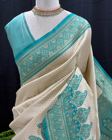 Ivory white brocade silk saree with teal blue border