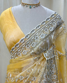 Lemon yellow soft organza saree with white embroidery all over saree.