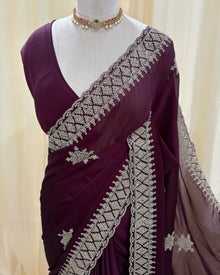 Magenta georgette saree with golden white embroidery.