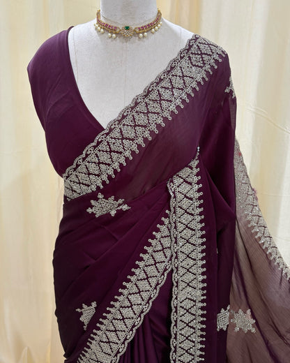 Magenta georgette saree with golden white embroidery.