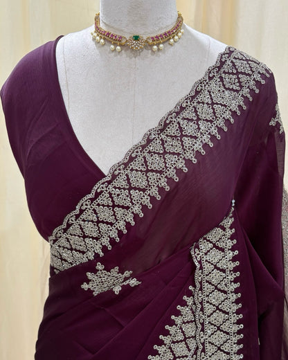 Magenta georgette saree with golden white embroidery.