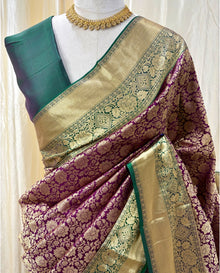 Magenta kanchipuram silk saree with peacock green border.