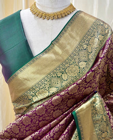 Magenta kanchipuram silk saree with peacock green border.