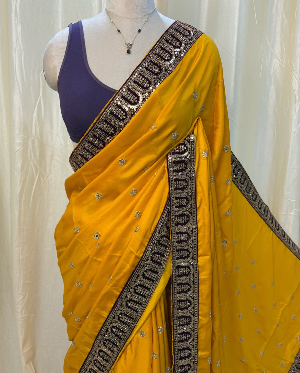 Mango yellow malai silk saree comes with Violet lace work saree.