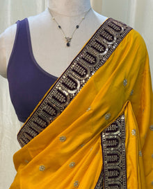 Mango yellow malai silk saree comes with Violet lace work saree.