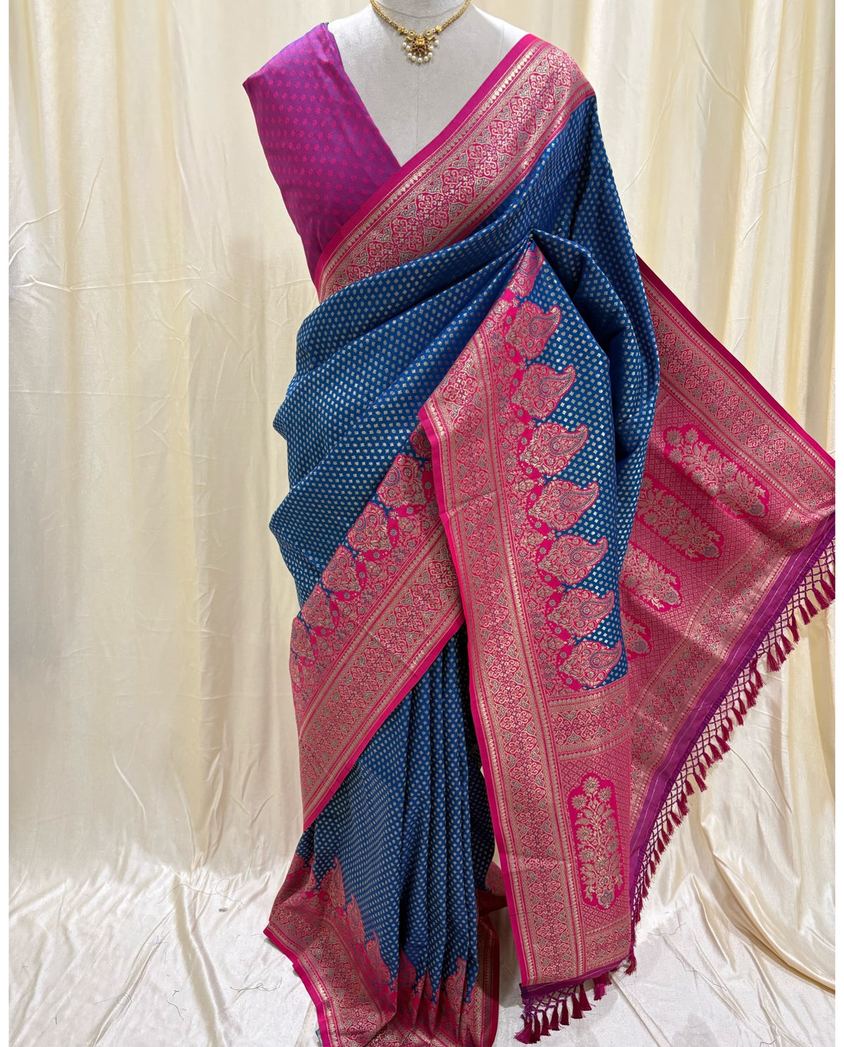 Navy blue brocade art silk saree comes with Rani pink border and pallu.