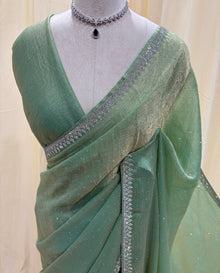Pastel green georgette sarees with white stones.