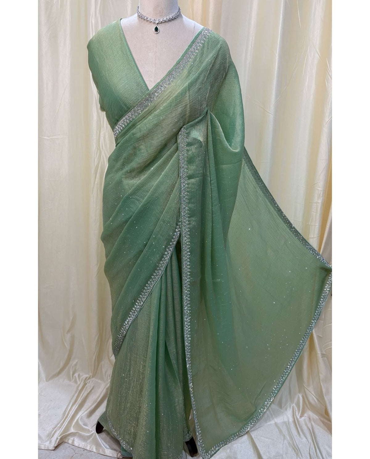 Pastel green georgette sarees with white stones.