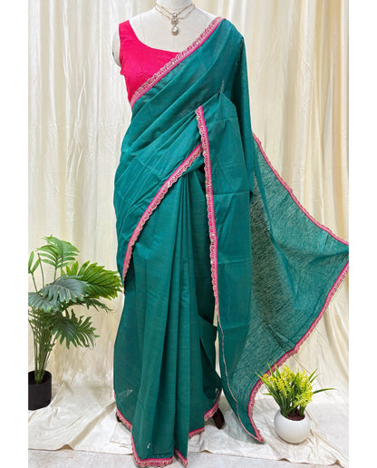 Peacock green dupion silk saree with pink border.