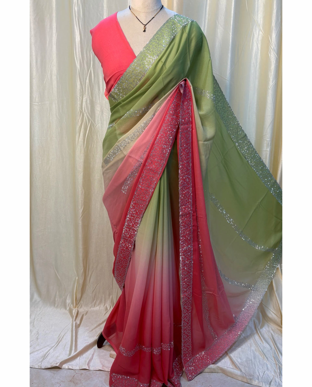 Pista green and pink half and half georgette saree.