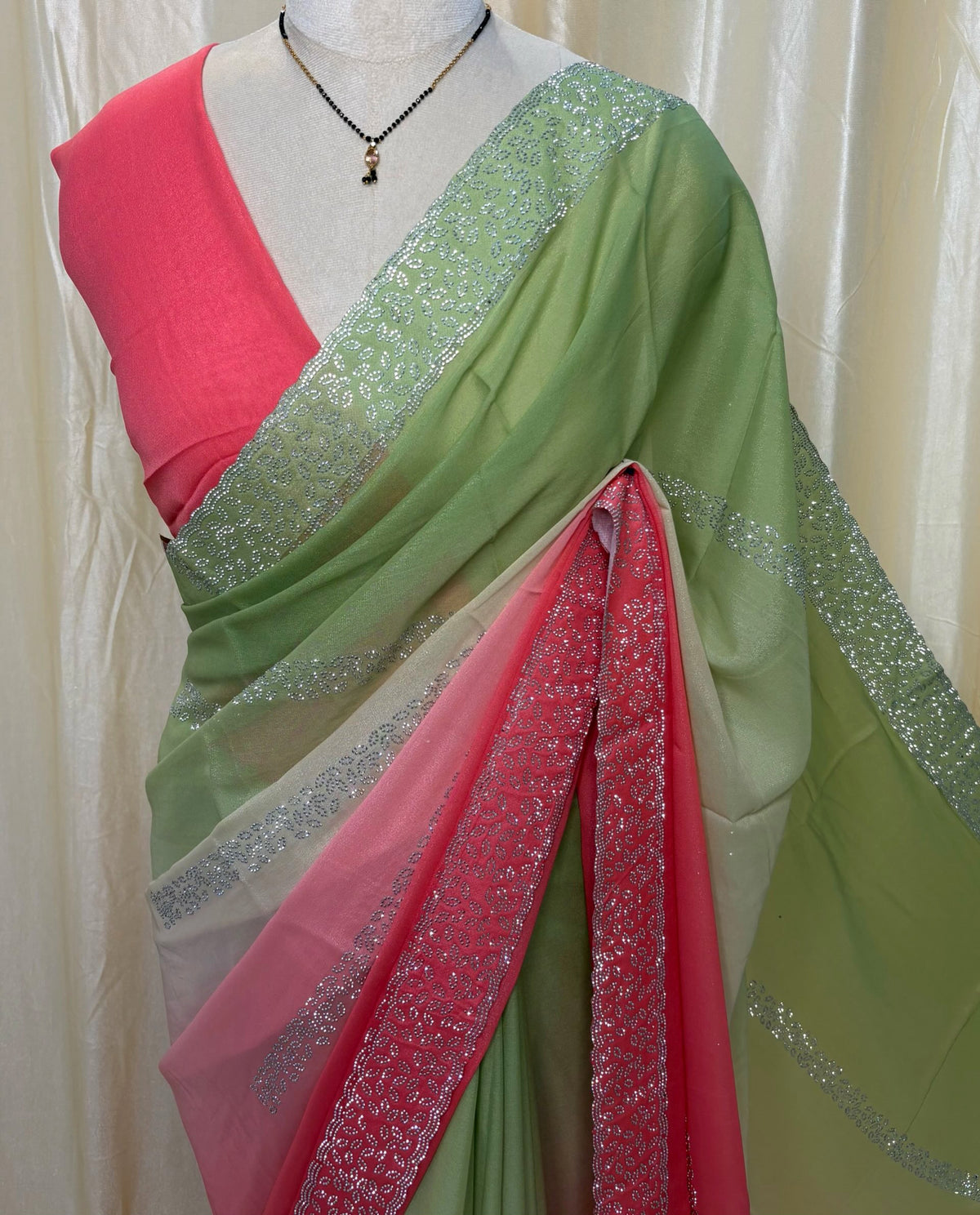 Pista green and pink half and half georgette saree.