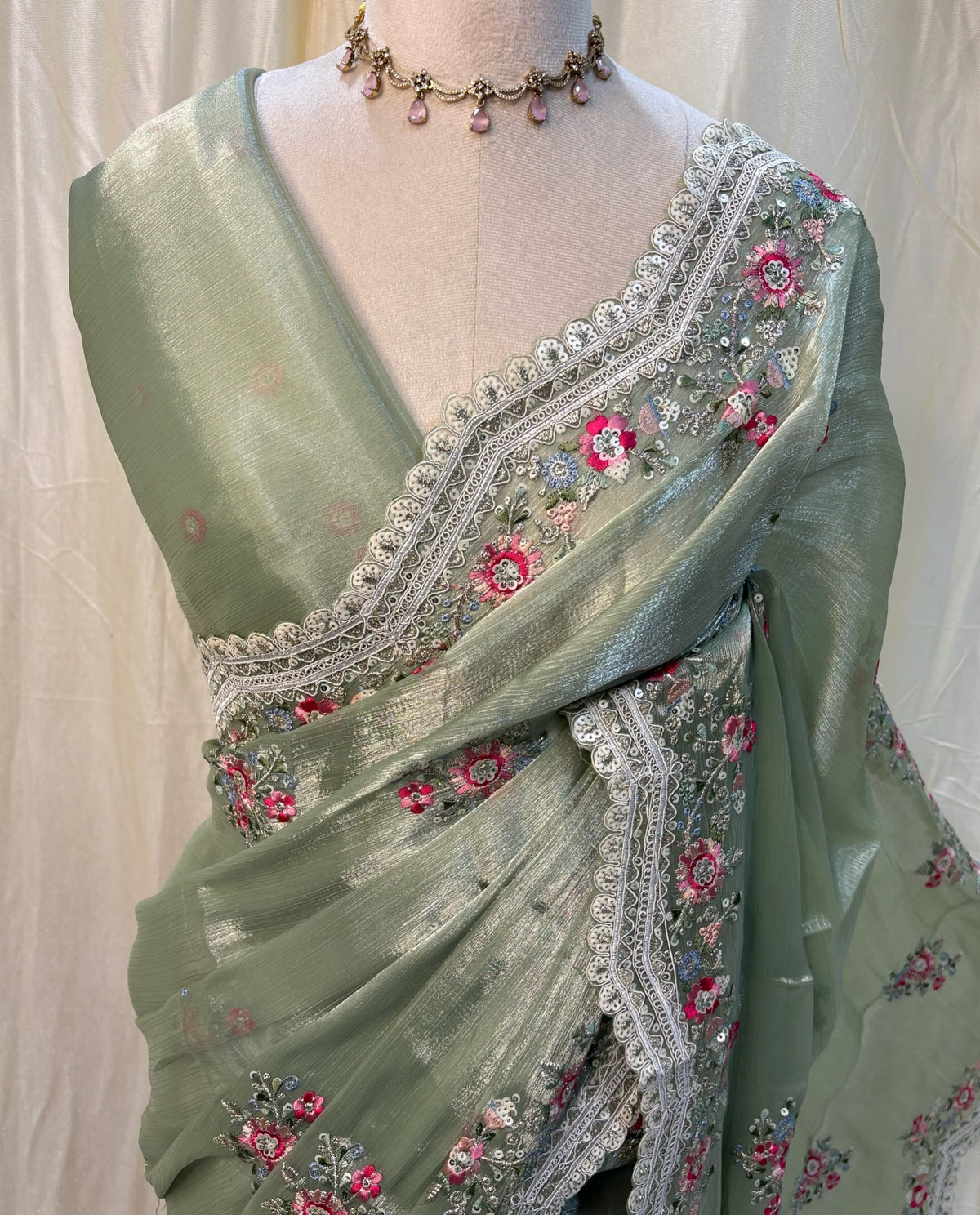 Pista green soft organza saree with white embroidery border.