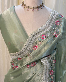 Pista green soft organza saree with white embroidery border.