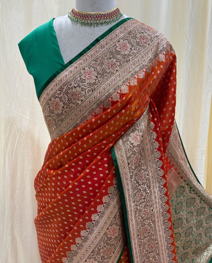Red orange satin silk sarees with green stoned border.