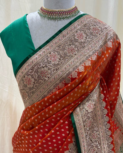 Red orange satin silk sarees with green stoned border.