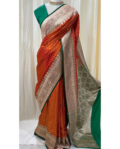 Red orange satin silk sarees with green stoned border.